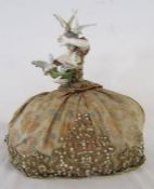 Lady wearing a crinoline dress tea cosy - ceramic figure of lady feeding birds - approx. 15cm