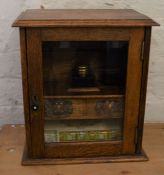 Victorian oak smokers cabinet (later used as stationery cabinet) with glass ink well & leather cigar