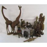 Collection of wooden figures includes tribal, giraffe, ebonised lion and elephant, crocodile etc