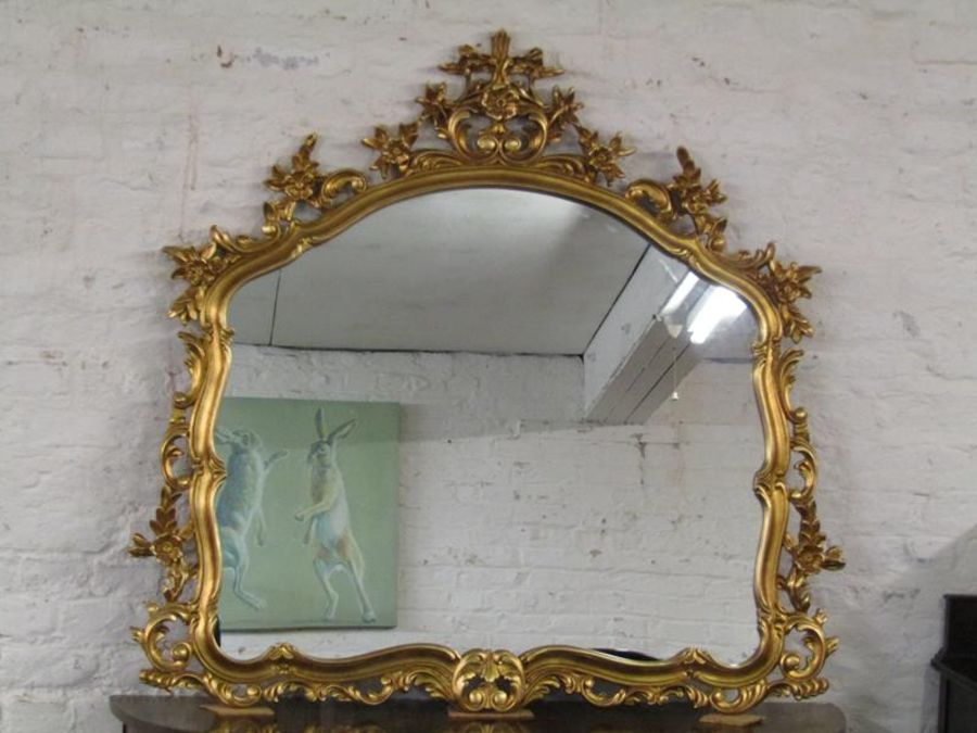 Ornately framed gilded mantel mirror Ht 116cm W 122c m