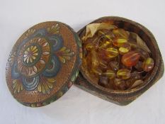 Large amber bead necklace (broken) in painted wooden box