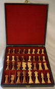 Case of carved wooden chess pieces