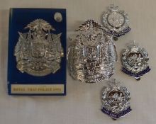 Three Royal Hong Kong Police cap badges (Firmin London & Firmin & Sons) & two Royal Thai Police