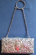 Silver purse with embossed floral decoration on silver chain with fitted leather interior Birmingham