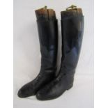 Long leather riding boots and wooden boot trees with brass pulls - boots marked 18795 G.T.H 1969