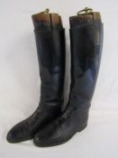 Long leather riding boots and wooden boot trees with brass pulls - boots marked 18795 G.T.H 1969