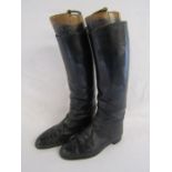 Long leather riding boots and wooden boot trees with brass pulls - boots marked G.T.H. 1969 M Size 9