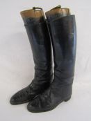 Long leather riding boots and wooden boot trees with brass pulls - boots marked G.T.H. 1969 M Size 9