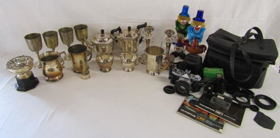 Collection of silver plate includes horn handled tankard, candlesticks, Murano style clowns (one