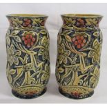 Pair of vases marked England with stag, trees and red berries design on a blue blackground - approx.