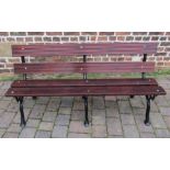 Wooden bench with three cast iron branch effect leg supports