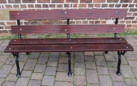 Wooden bench with three cast iron branch effect leg supports