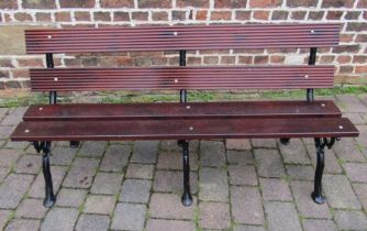 Wooden bench with three cast iron branch effect leg supports