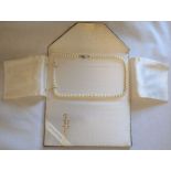 Mikimoto string of graduated pearls in a Lane Crawford Hong Kong wallet, length 47cm, weight 22.98g,