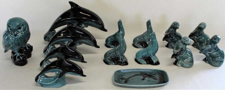 Selection of Poole animal figures, including graduating dolphins and dish, seals, otters and owl