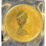 1985 Canadian 10 dollar quarter ounce gold coin in a plastic pouch