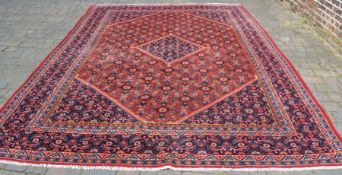 Large full pile red ground Persian Beshir carpet 4.0m by 2.9m