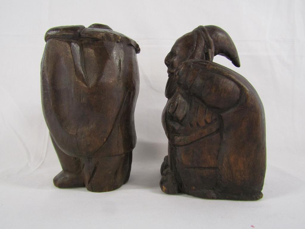 Two wooden carved figures - one possibly Santa carrying a sack and the other of a lady holding her - Image 2 of 4