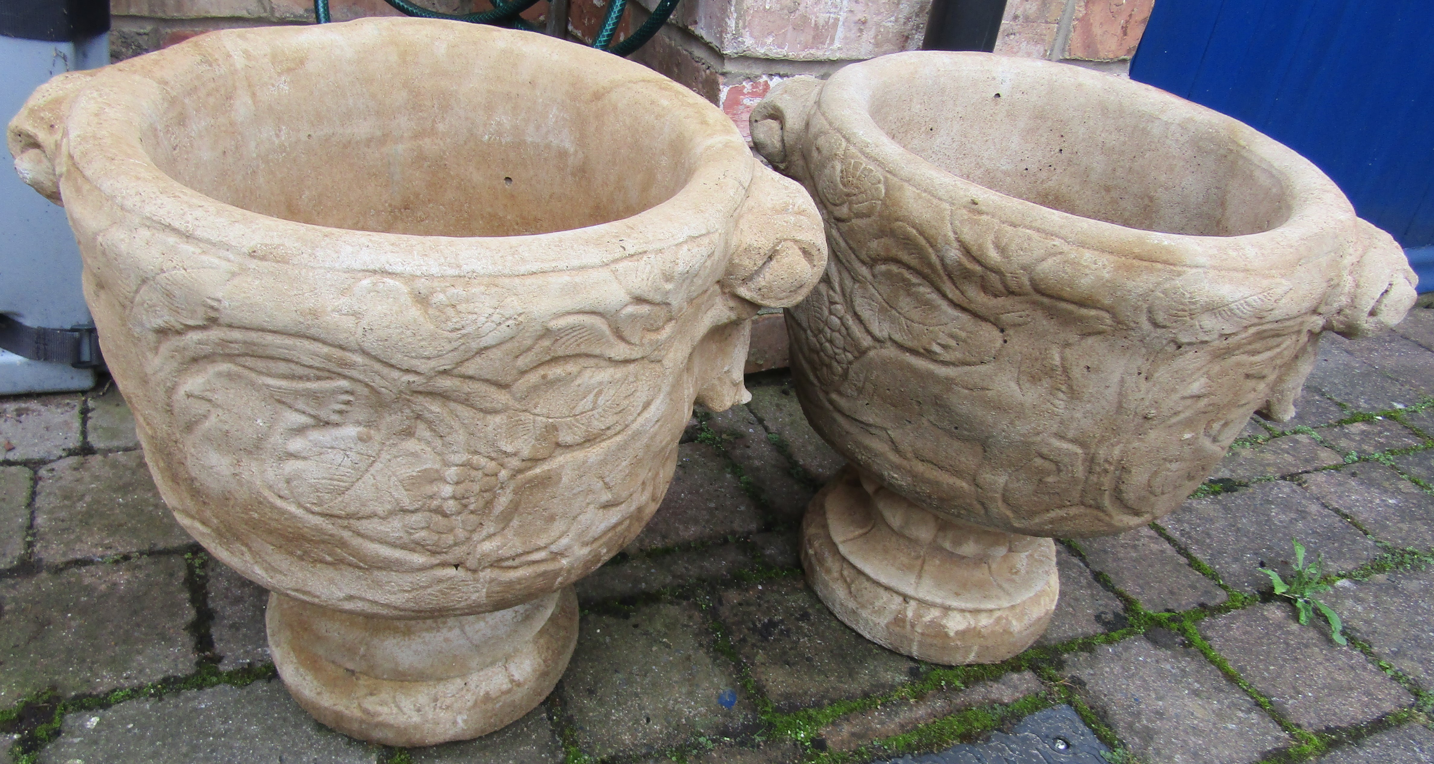 Pair of concrete urns featuring stags & tropical birds