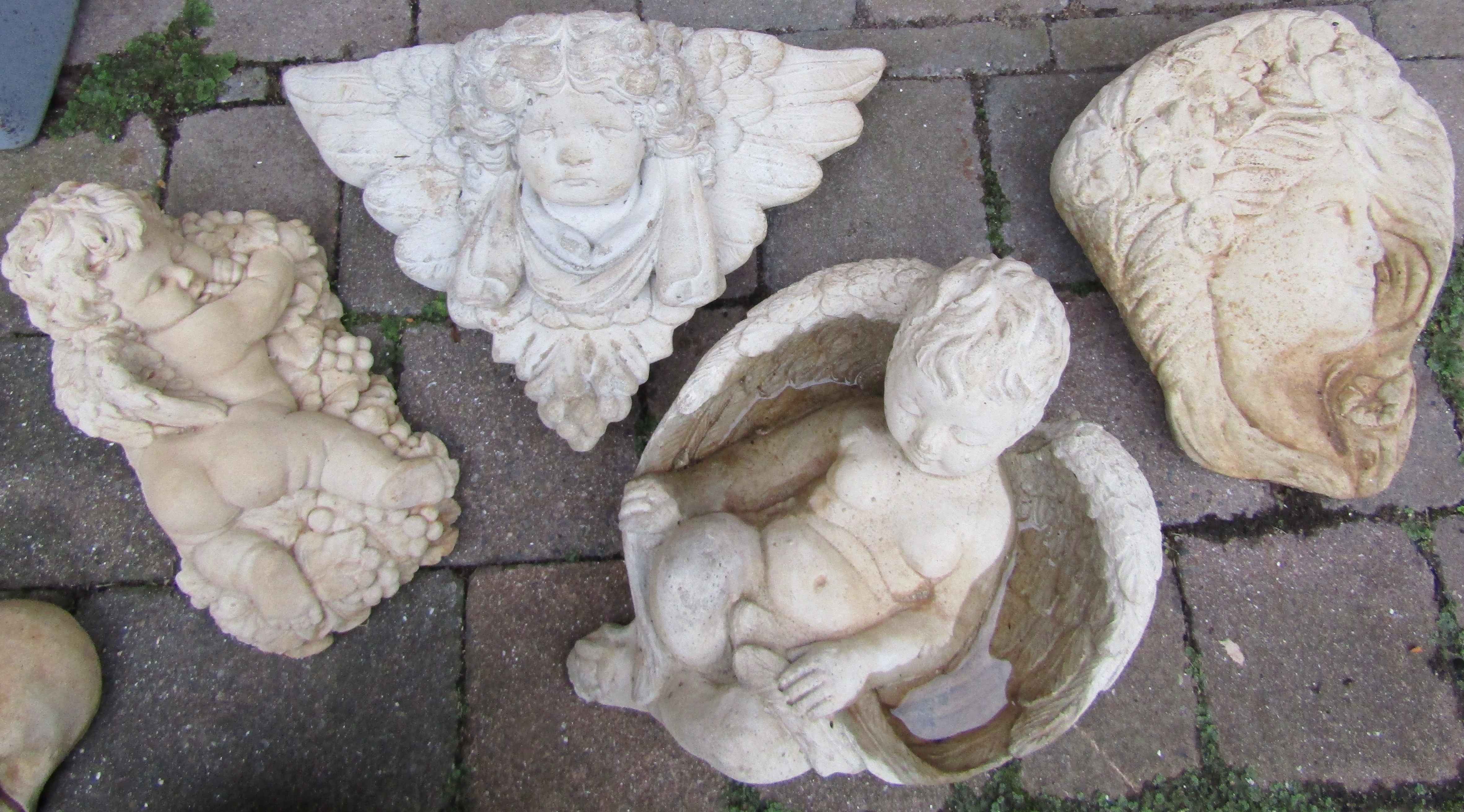 Selection of decorative concrete garden items:- Bacchus cherub lying on a bed of grapes, Cherub's