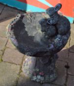 Concrete bird bath with rabbit figures