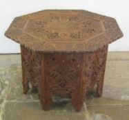 Large Oriental carved hardwood table on folding base with snake design - approx. 83cm x 59cm