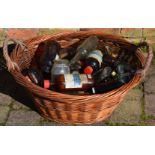 Wicker basket containing vintage glass bottles