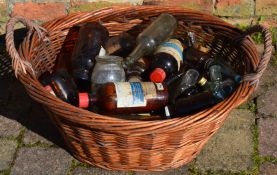 Wicker basket containing vintage glass bottles