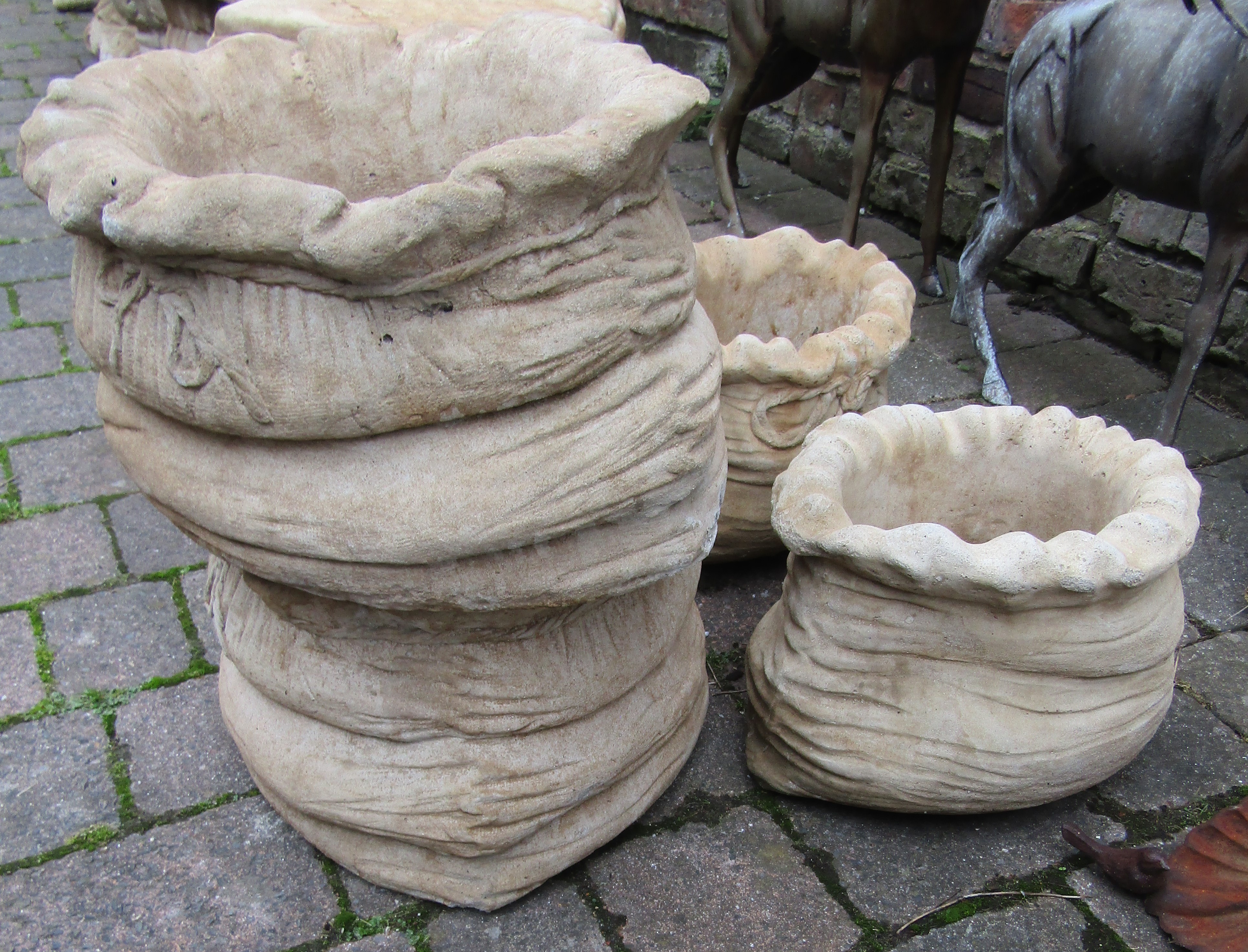 Pair of large and a pair of small sack shaped concrete planters