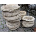 Pair of large and a pair of small sack shaped concrete planters