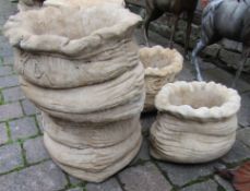 Pair of large and a pair of small sack shaped concrete planters