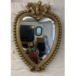 Heart shape mirror in a gold painted frame with cherubs aloft Ht 60cm X 43cm
