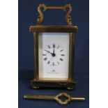 Small brass timepiece carriage clock by Matthew Norman, with Swiss 11 jewels movement & key (