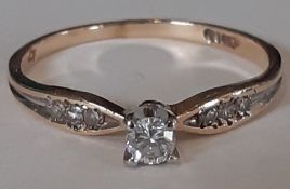 14k gold diamond solitaire ring with diamond set shoulders, central stone approx. 0.10ct, total 0.