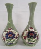 Near pair of Moorcroft long necked vases with Persian designs in panels on green, signed William