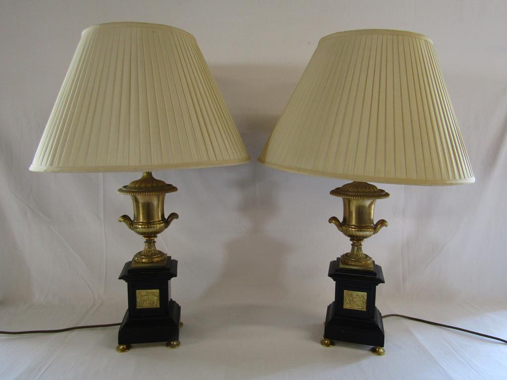 Pair of black slate table lamps with gold urn tops and decorative inserts