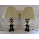 Pair of black slate table lamps with gold urn tops and decorative inserts