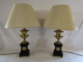 Pair of black slate table lamps with gold urn tops and decorative inserts