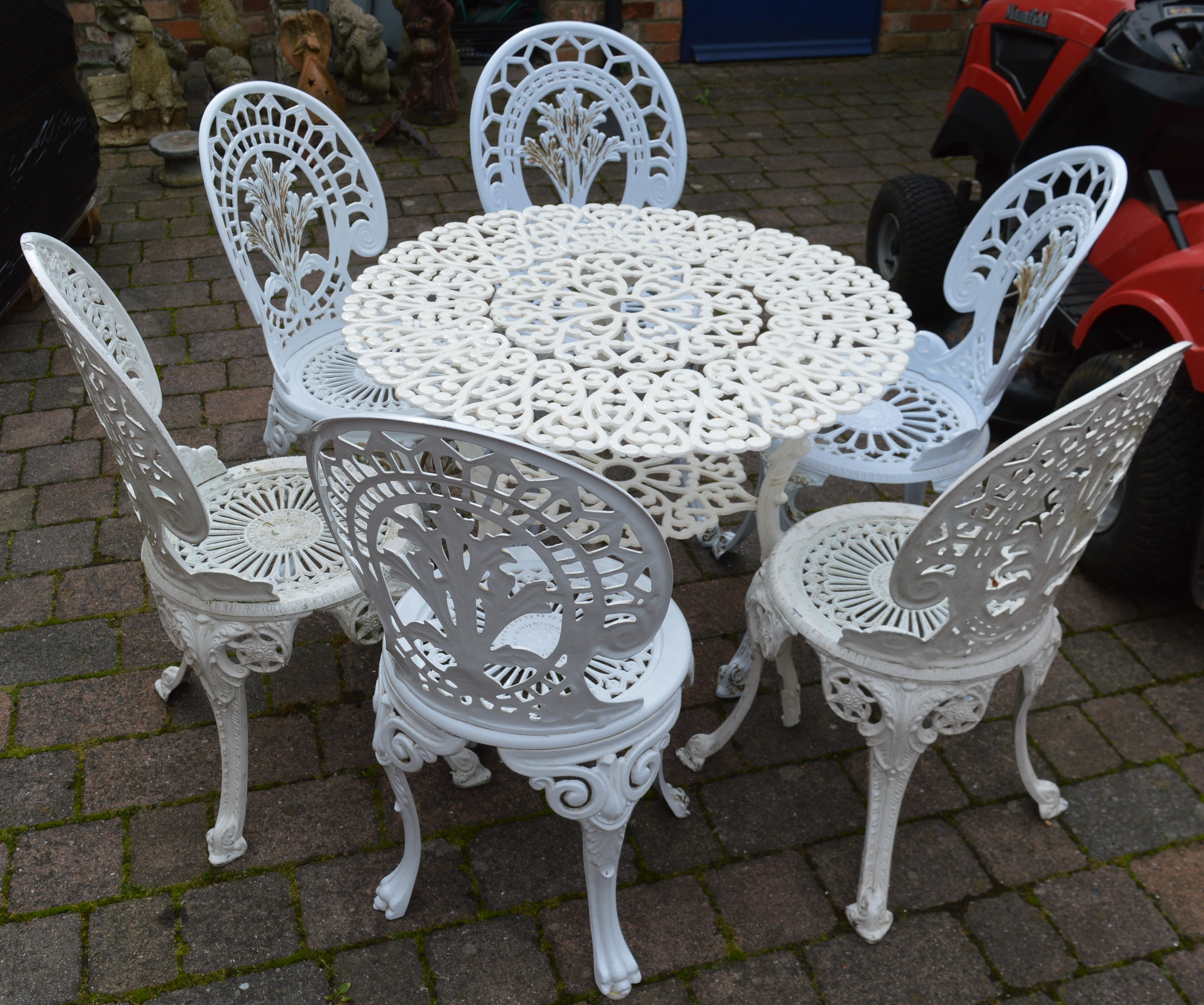 Cast alloy table and 4 chairs and two other cast chairs