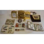 Selection of clocks including Timemaster and Rhythm Quartz clocks and cigarette cards