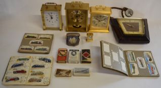 Selection of clocks including Timemaster and Rhythm Quartz clocks and cigarette cards