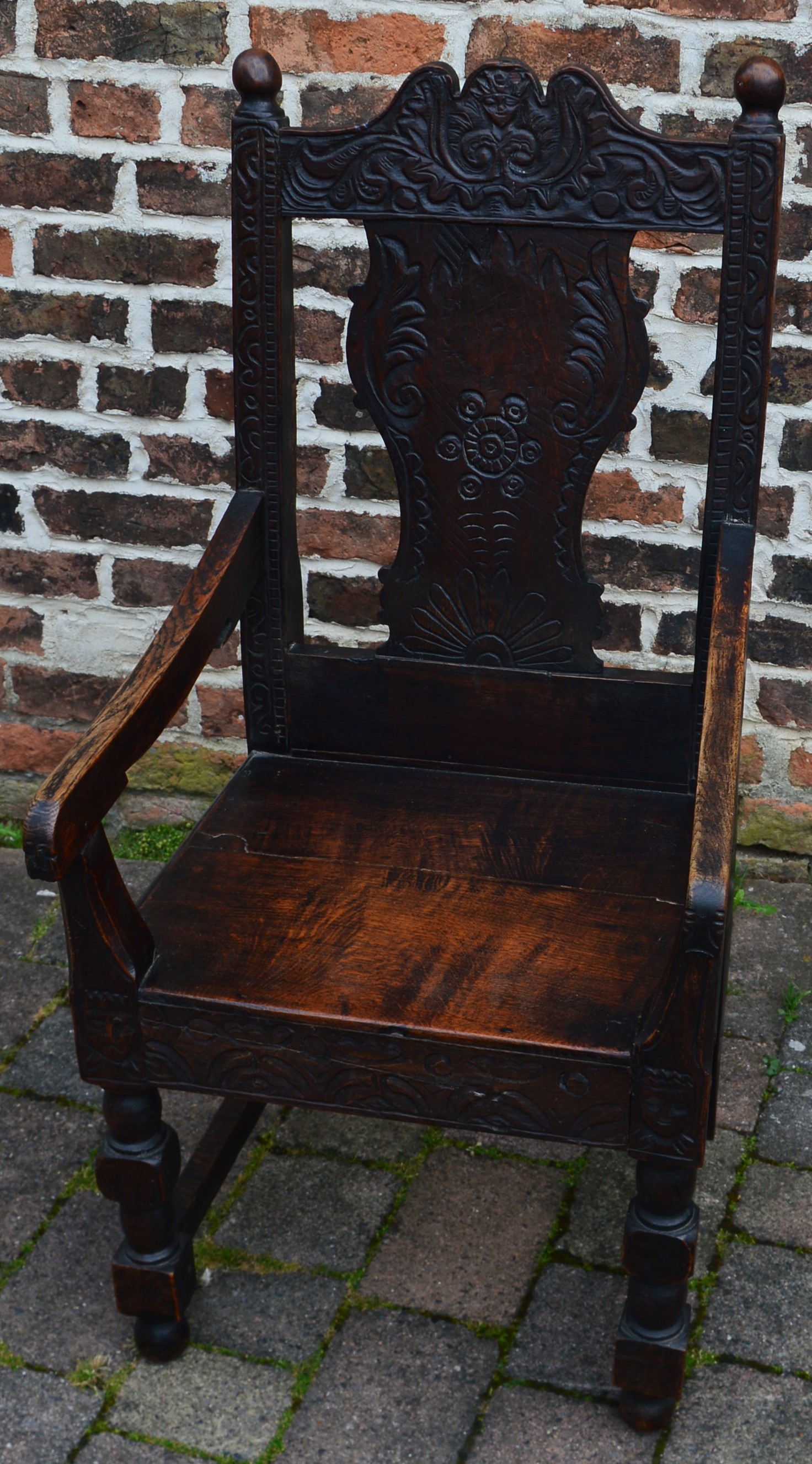 Reproduction 17th century wainscot carved oak chair with loose cushion seat