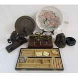 Collection of items includes wooden horse, mounted brass cannon, sundial, Heredities figure, hand