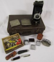 Small suitcase with contents includes Brownie camera, pocket knives, cigarette cases and