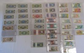 Folder containing world bank notes includes Brazil, Bulgaria, Cambodia, China, Ghana