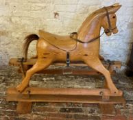 Carved wooden rocking horse in pitch pine Ht92cm L 112cm