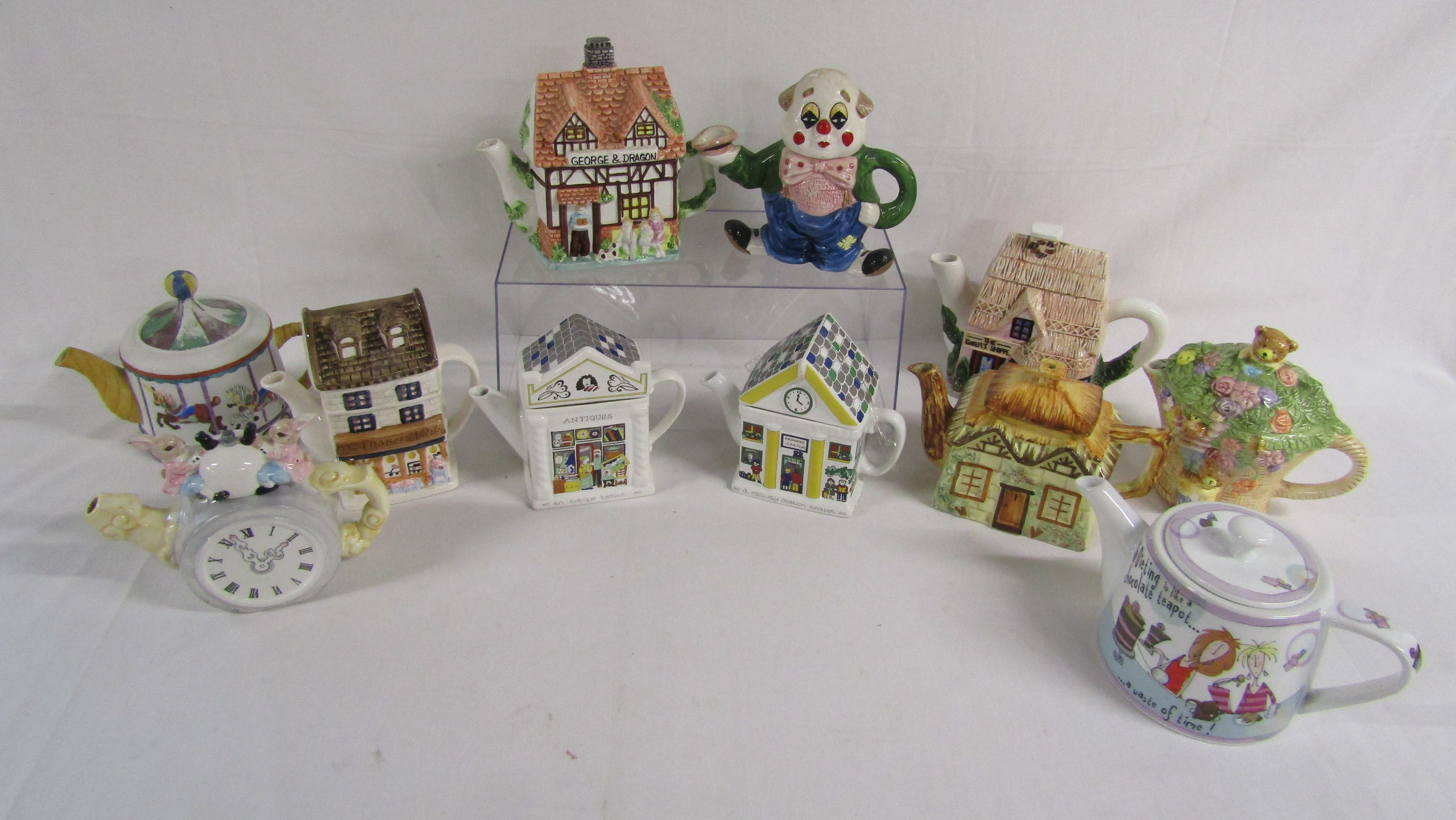 11 teapots include Christopher Wrens amazing fairground, bakers, Wade Antique shop and Primrose