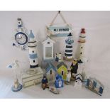 Collection of wooden beach ornaments includes, clock, lighthouses, beach hut money boxes, candle