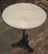 Cast iron pub table with marble top. Diameter 60cm Ht 70cm