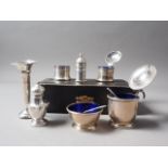 A three-piece silver cruet set, in box, another mustard pot, a salt cellar with blue glass liner,